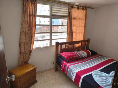 a bedroom with a bed in front of a window at Hotel Escocia in Estación El Salto
