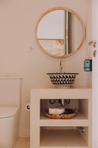 a bathroom with a sink and a mirror at Herdade D’ Amoreira Aljezur in Aljezur