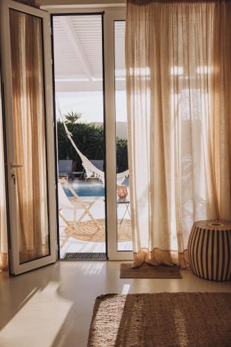 an open glass door with a view of a patio at Herdade D’ Amoreira Aljezur in Aljezur