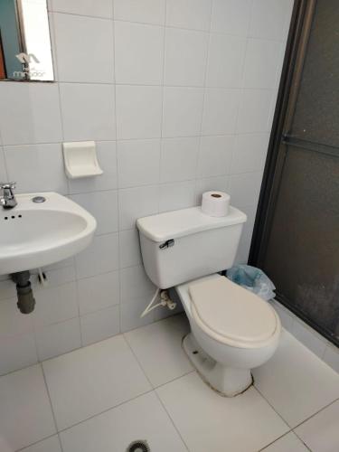 a bathroom with a toilet and a sink at Hotel Galerias in Ruiosucio