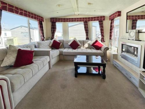 a living room with a couch and a fireplace at Seaview Holiday Park - 2 bedroom sleeps 6 Family & Pet friendly in Chestfield