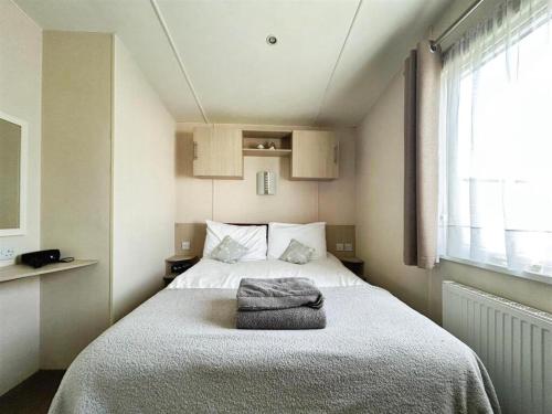 a bedroom with a bed with a towel on it at Seaview Holiday Park - 2 bedroom sleeps 6 Family & Pet friendly in Chestfield