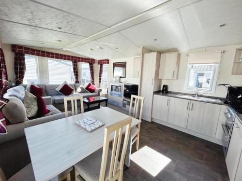 a kitchen and living room with a table and a couch at Seaview Holiday Park - 2 bedroom sleeps 6 Family & Pet friendly in Chestfield