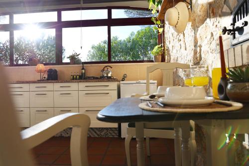 a kitchen with a table with a plate of food on it at Quinta Ivonne in Montemor-o-Velho