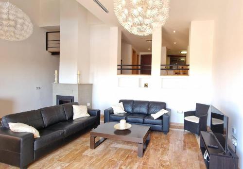 a living room with a couch and a coffee table at Luna-Villa de Riviera with Sea-View in Mijas Costa