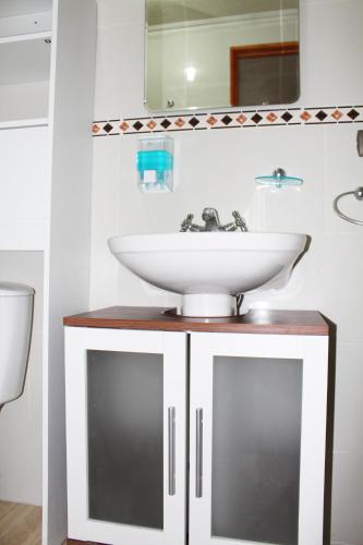 a bathroom with a sink and a mirror at Residencial Victoria Said in Linares