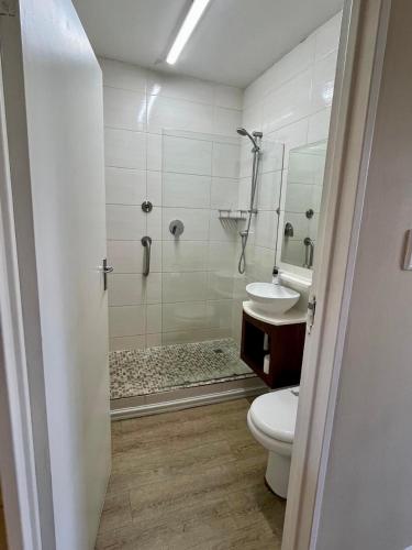 a bathroom with a shower and a toilet and a sink at Oceanic 2 Bedroom Apartment - Ocean and Park View - Self-Catering in Durban