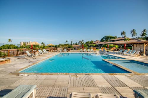 a pool at a resort with lounge chairs at Kaanapali Maui at the Eldorado by OUTRIGGER in Lahaina