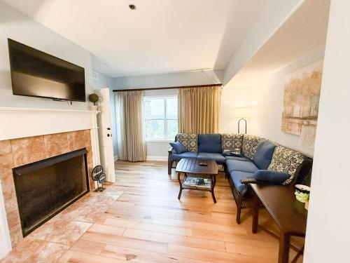 a living room with a couch and a fireplace at Fairway To Heaven At Four Season 2bed2bath Condo in Lake Ozark