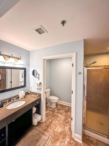 a bathroom with a toilet and a sink and a shower at Fairway to Heaven at Four Season 2BED2BATH Condo in Lake Ozark