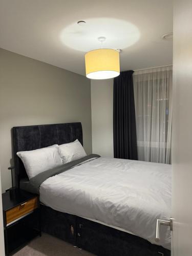 a bedroom with a large bed and a window at Chalk in Moffat
