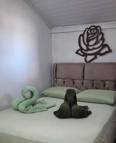 a bedroom with a bed with two stuffed animals on it at Moradas Jane in Paulo Lopes