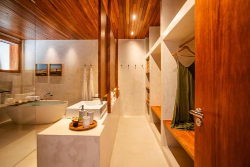 een badkamer met een bad, een wastafel en een toilet bij Casa Siará Preá in Prea