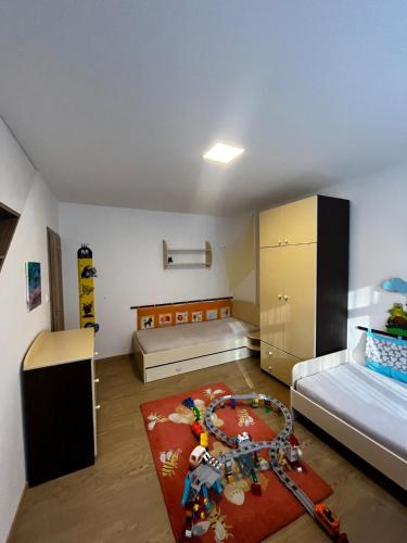 a small room with two beds and a rug at Baťovský dům ZLÍN in Zlín