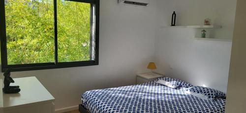 a bedroom with a bed and a window at Architect-designed villa, overlooking Agay Bay in Saint-Raphaël