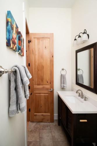 a bathroom with a sink and a wooden door at Quiet, gated oasis near downtown Lexington in Lexington