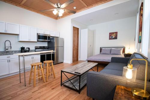 a kitchen and a living room with a couch and a table at Quiet, gated oasis near downtown Lexington in Lexington