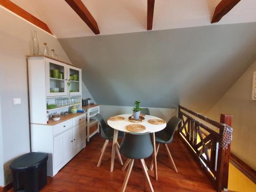 a kitchen with a table and chairs in a room at Santa Maria in Ferdinandshof