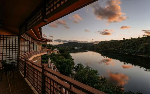a view of a river from the balcony of a house at Hotel Rural Quinta da Conchada in Aguieira