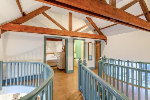 a room with a staircase with blue railings at 4 Bed in Shebbear oc-w33730 in Black Torrington