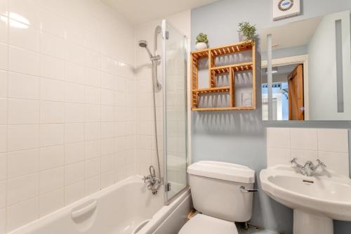 a bathroom with a sink and a toilet and a shower at 4 Bed in Shebbear oc-w33730 in Black Torrington