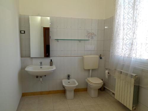 a bathroom with a toilet and a sink at Seven B&b in Casalmorano