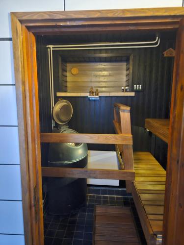 a small cabinet with a toilet in a room at Perniön majoitus alakerta in Perniö