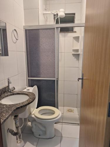 a bathroom with a toilet and a sink and a shower at Apartamento Condomínio Turu a 6km da Praia in Maioba