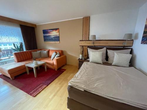 a living room with a bed and a couch at Cozy Apartment in Inzell in Inzell