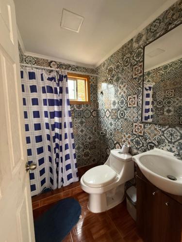 a bathroom with a toilet and a sink at Cabañas Montesol Mejor Vista a las estrellas in Choapa