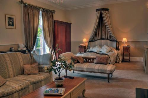 a living room with a bed and a couch at Albert Cottage Hotel in East Cowes