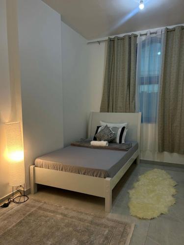 a bedroom with a bed and a rug at Vi Home Stay in Abu Dhabi