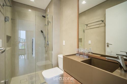 a bathroom with a toilet and a sink and a shower at Full Loft 290 m from the Beach CPH0202 in Florianópolis