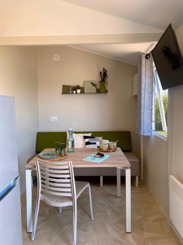 a dining room with a table and two chairs at Camping Le Solitaire du Lac in Saint-Jorioz