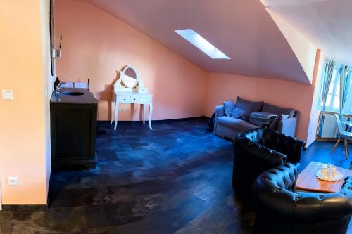 a living room with a couch and a table at Weingut Mathis Apartment 1 Burgblick in Klingenmünster