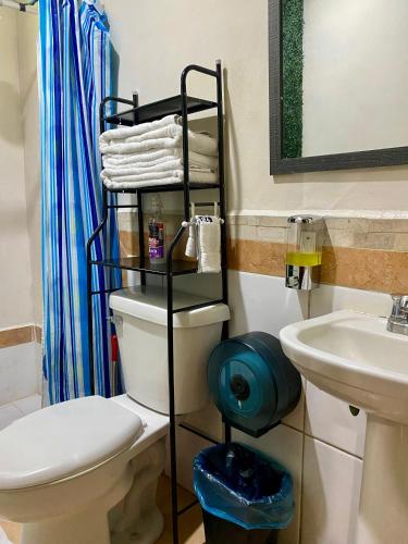 a bathroom with a toilet and a sink at La Casita in San Pedro Sula