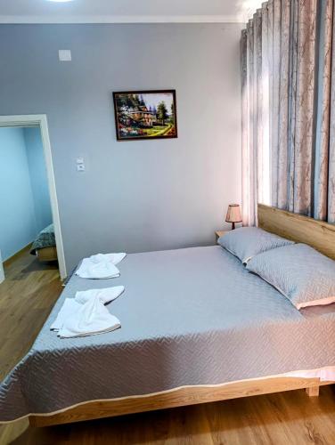 a large bed in a room with a window at Spacious Waterfront 3BR - 2Bath & 3 Panoramic Balconies - Pogradec, Lake Ohrid in Pogradec