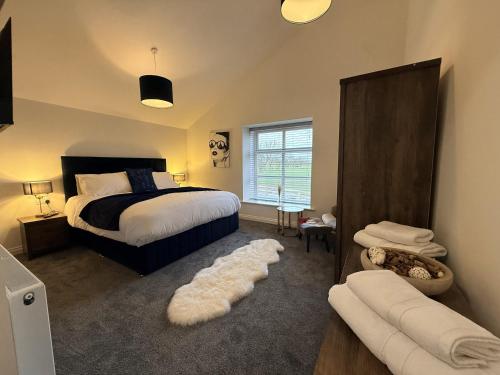 a bedroom with a bed and a couch in it at The Barn in Skipton