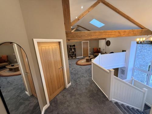 a large room with a ceiling with wooden beams at The Barn in Skipton