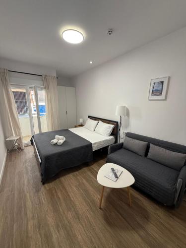 a bedroom with a bed and a couch at HS Beach in Torrevieja