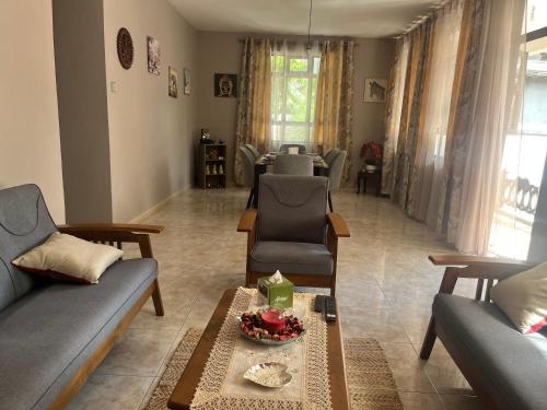 a living room with two couches and a table at House Raghu in Rose Belle
