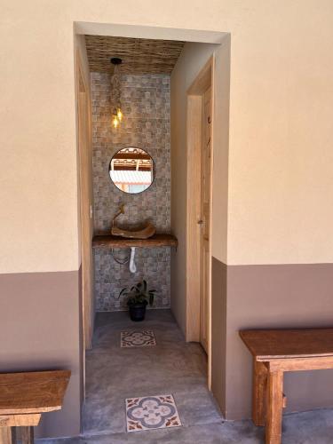a hallway of a house with two benches and a mirror at Recanto das Águas in Cunha