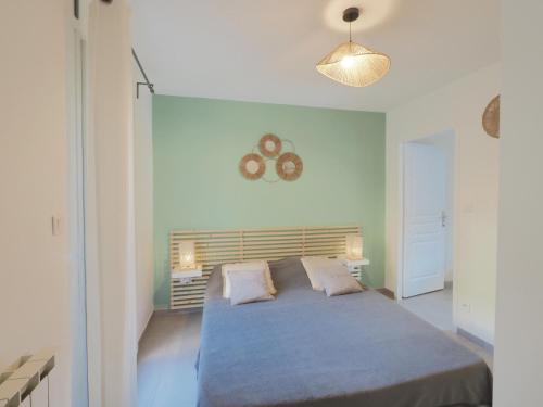 a bedroom with a large bed with two pillows at gitelepetitvallon in Allemagne-en-Provence