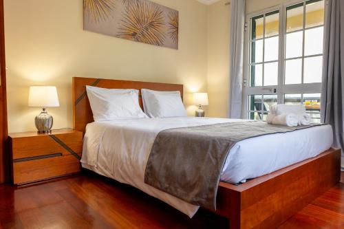 a bedroom with a large bed and a window at View to the Valley, By OP in Senhora do Rosário