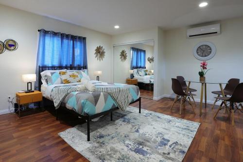 a bedroom with a bed and a living room at Modern Oasis Studio - near LAX, SoFi, USC, DTLA in Los Angeles