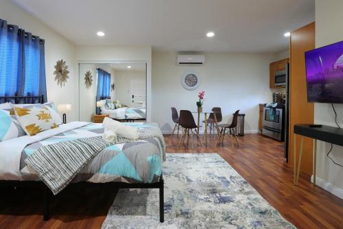 a bedroom with a bed and a living room at Modern Oasis Studio - near LAX, SoFi, USC, DTLA in Los Angeles