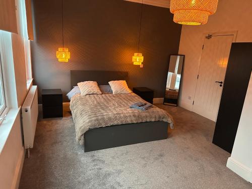 a bedroom with a bed and two lamps and a mirror at Norton Rd Guest House in Stockton-on-Tees