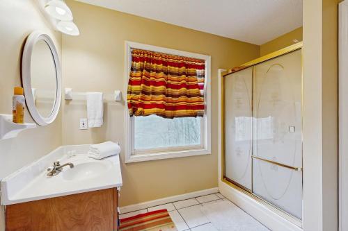 a bathroom with a sink and a shower at Lakeledge Hideaway in Beech Mountain