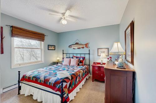 a bedroom with a bed and a desk and a window at Lakeledge Hideaway in Beech Mountain