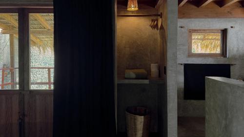a living room with a fireplace and a window at Lalito in Zipolite